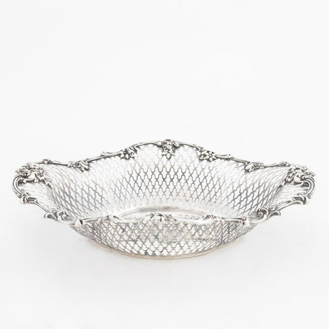 ROGER WILLIAMS SILVER CO, PIERCED STERLING BASKET: Roger Williams Silver Co. circa 1900-1913. Pierced sterling silver basket with floral rim. Appropriately marked. Approx. w. 11.5", 14.55 ozt. Item from the Estate of Forest "Tag" Hunter, Atlanta, GA.