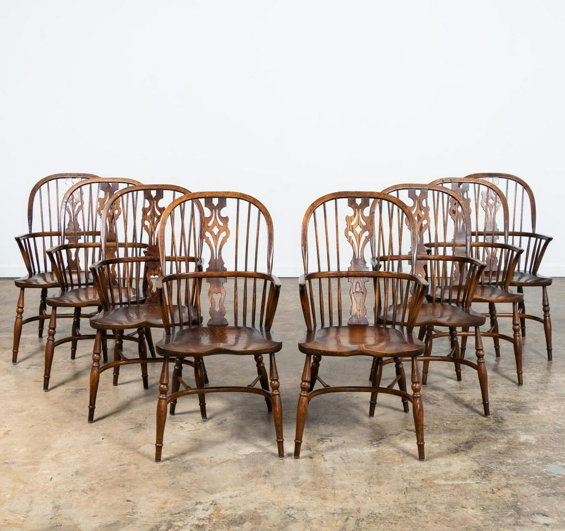 SET, EIGHT OAK WINDSOR STYLE DINING CHAIRS: American, 20th century. Set of eight carved oak Windsor style armchairs having a pierced splats, saddle seats, and rising on turned legs with stretchers. Unmarked. Approx. of one, h. 42", w. 20.75", d