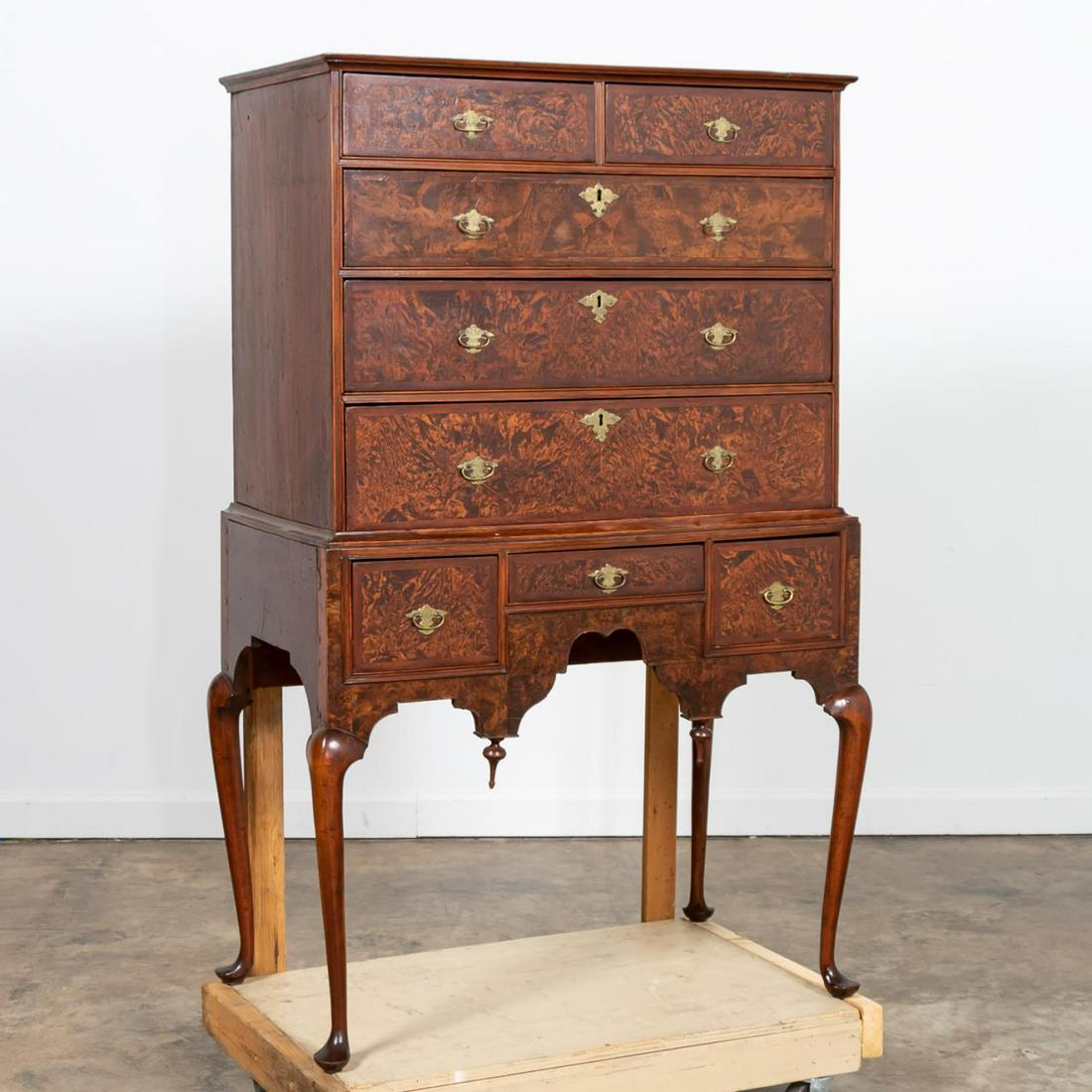 18TH C. NEW ENGLAND QUEEN ANNE CHEST ON STAND: American, New England, possibly Massachusetts, second quarter 18th century. Burled walnut veneer and pine frame Queen Anne chest on stand or highboy, having a shaped cornice above two aligned drawers,