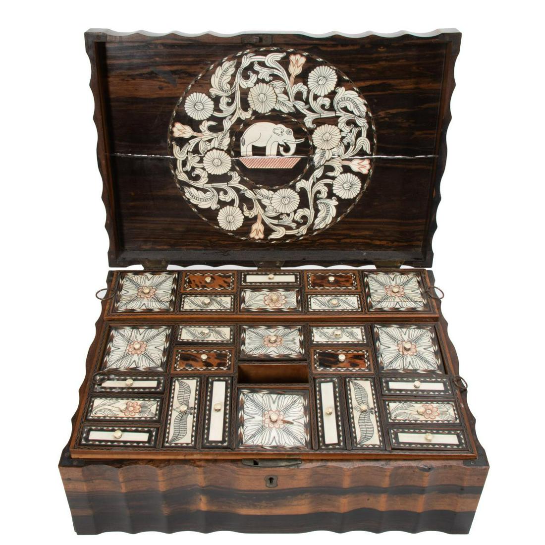 19TH / 20TH C. ANGLO-INDIAN COROMANDEL SEWING BOX: Anglo-Indian, late 19th / early 20th century. Coromandel or calamander, mixed wood and bone inlaid sewing or work box having a fluted case, lid decorated with an elephant and interior fitted with mult