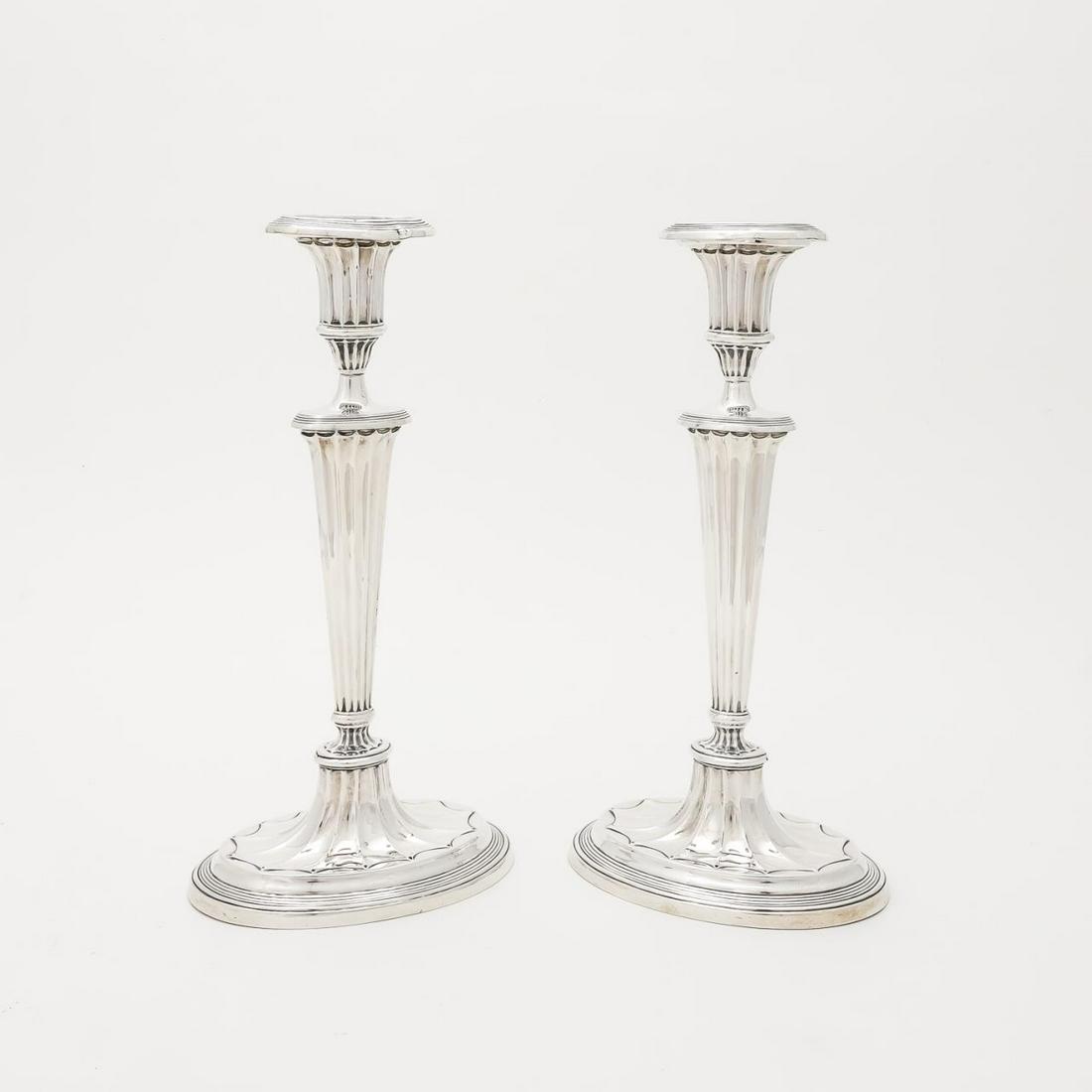 PAIR, GEORGE VI STERLING SILVER CANDLESTICKS: Ellis Jacob Greenberg (English, founded, 1850), 1938. Pair of weighted sterling silver candlesticks in the Adams taste having fluted bodies on oval bases. Birmingham, date, assay, and maker's marked t
