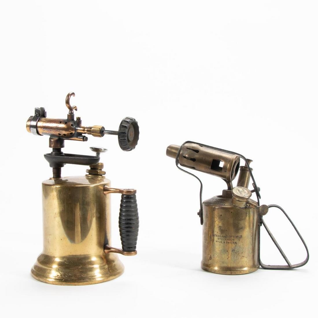 2 PIECES, BRASS BLOW TORCHES, ONE NOBEL BRAND: Continental, early 20th century. Group of two brass blow torches, one marked "Nobel, Sweden" and the other apparently unmarked. Approx. h. 11" (tallest) Item from the Estate of Forest "Tag" Hunter, At