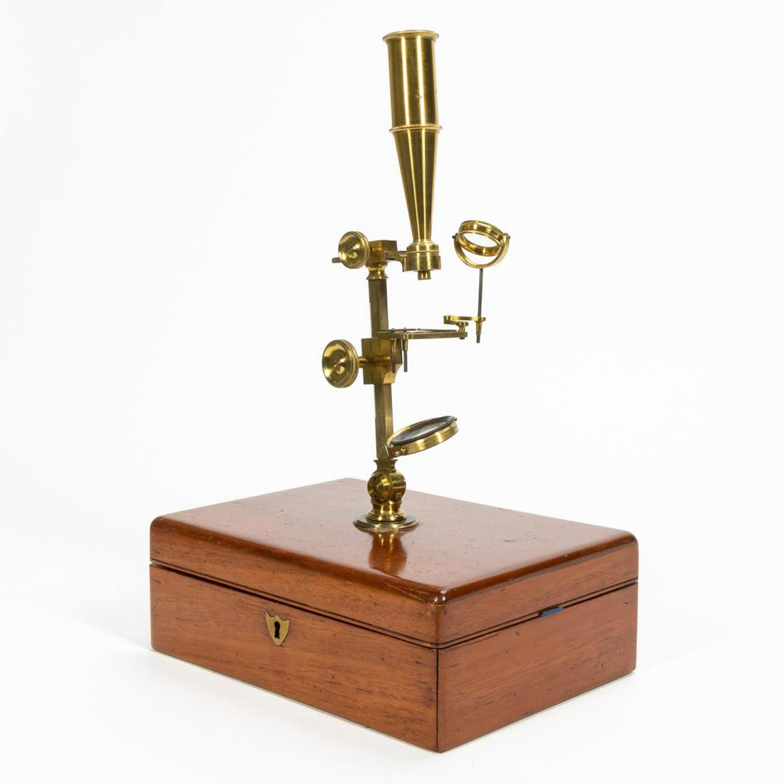 19TH C. WILLIAM CARY GOULD-TYPE MICROSCOPE IN CASE: William Cary (English, 1759-1825), early 19th century. Monocular brass Gould-type compound microscope, having an adjustable arm, gimbaled plano/concave mirror, and in a mahogany case; together with an