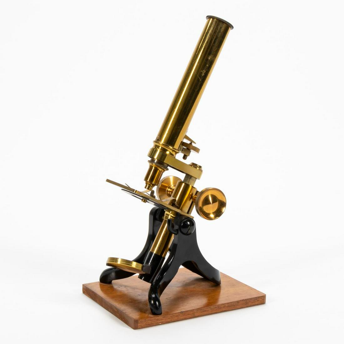 E. 20TH C. ENGLISH BRASS MONOCULAR MICROSCOPE: English, early 20th century. Lacquered brass monocular microscope, with rectangular stage, on black stand, and mounted on a wooden base. The eyepiece marked '2', but otherwise unmarked. Approx. h. 13"