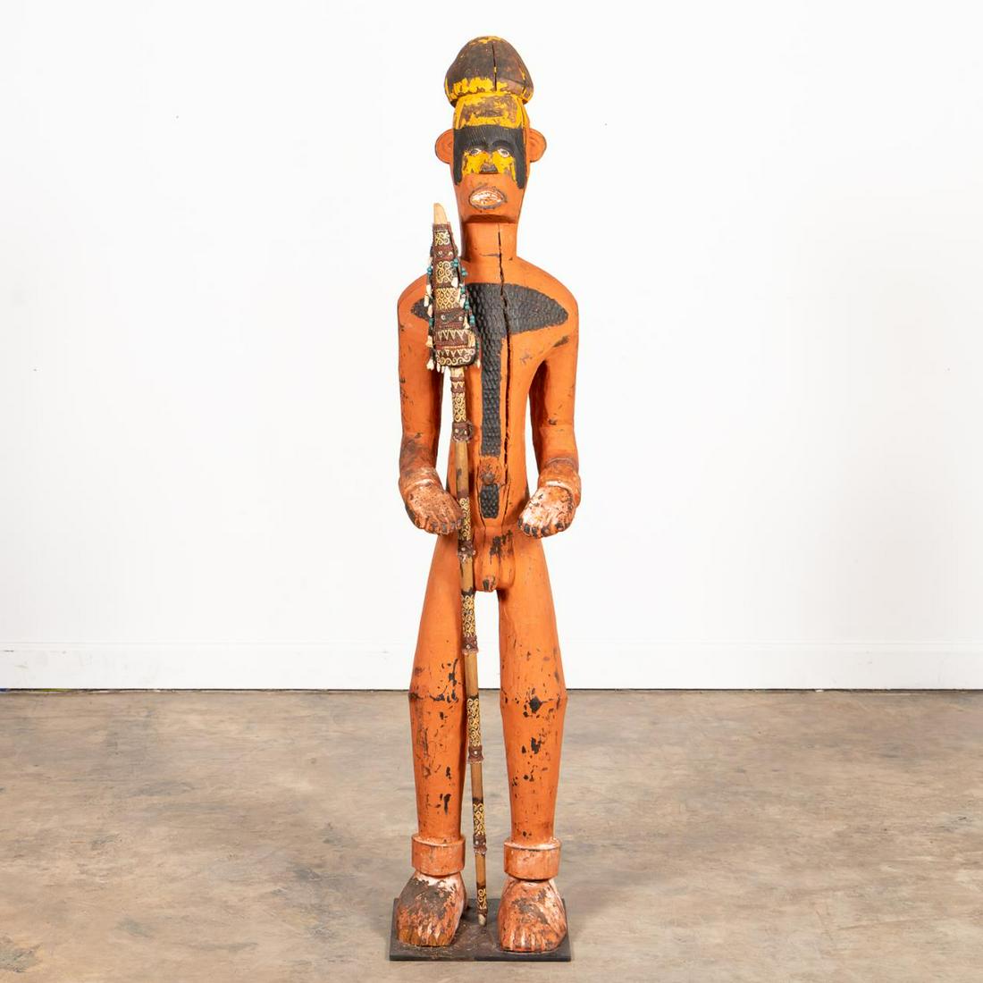 LARGE AFRICAN POLYCHROME DRC TEKE FIGURE W/ SPEAR: Central Africa, Democratic Republic of the Congo. Large standing male Teke figure with red orange polychrome pigment, scarification, exposed teeth and is holding a spear. Accompanied by custom stand. 
