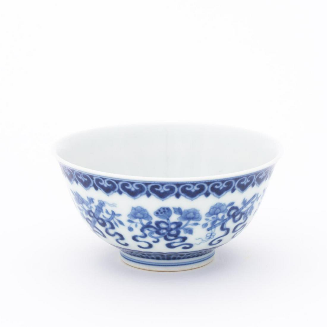 SMALL CHINESE BLUE & WHITE PORCELAIN BOWL: Chinese. Small blue and white porcelain rice bowl having bat motif border. Qianlong style mark to underside. Approx. h. 2.5", diam. 5.25".