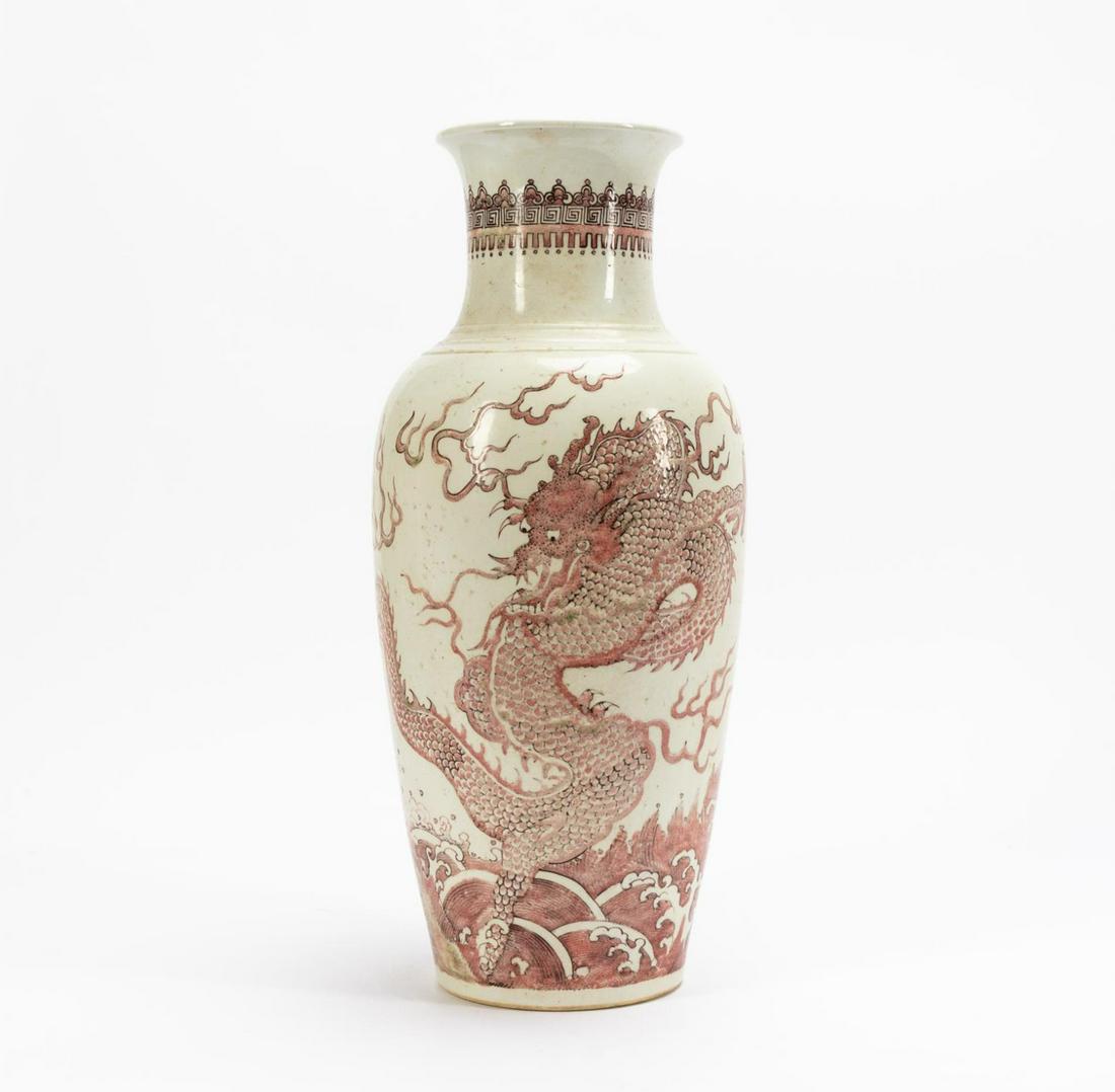 CHINESE RED & WHITE FLORAL MOTIF BALUSTER VASE: Chinese. Iron red and white, baluster form, porcelain vase with dragon in the clouds scene. Character mark to underside, Kangxi style. Approx. h. 17.5".