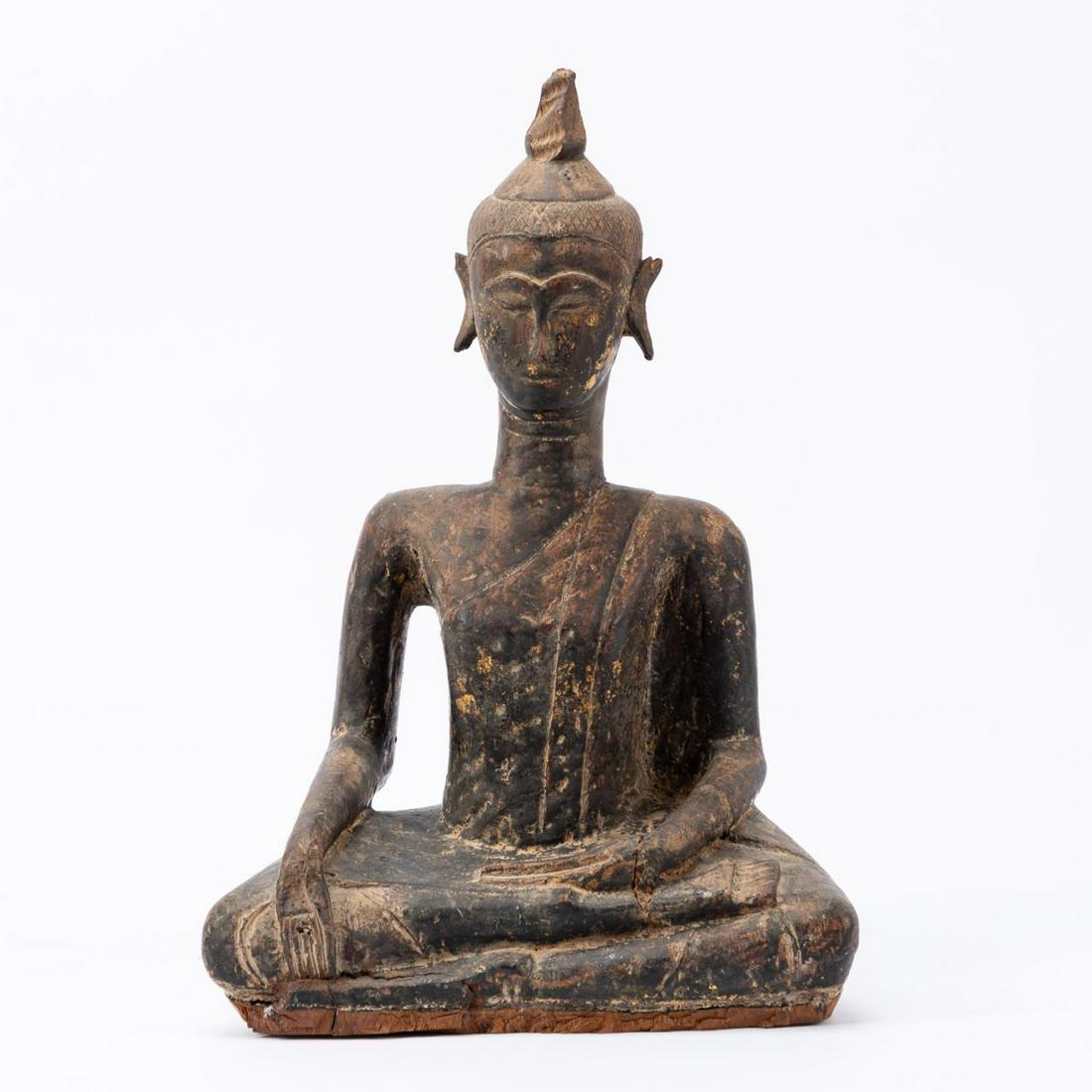 SOUTHEAST ASIAN CARVED WOOD BUDDHA SCULPTURE: Southeast Asian. Carved wood seated in the gesture of Bhumisparsha mudra and having faint scattered gilt and layer of polychrome. Apparently unmarked. Approx. h. 17".