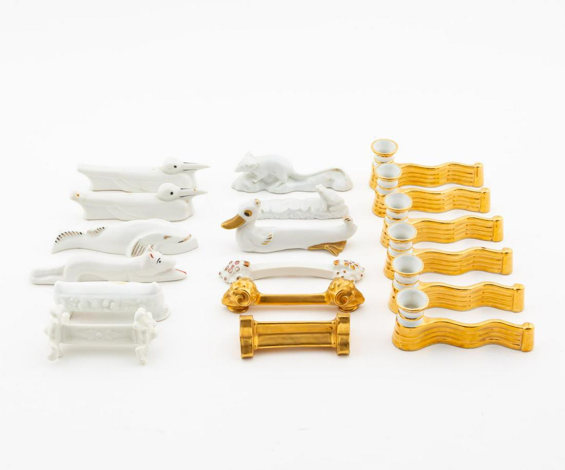 EIGHTEEN PORCELAIN KNIFE RESTS, VARIOUS: English and Continental, 20th century. Group of eighteen porcelain knife rests comprising: five animal form, including six Marcel Chaufriasse (Limoges) rests/placecards, one floral pattern (Limoges), 