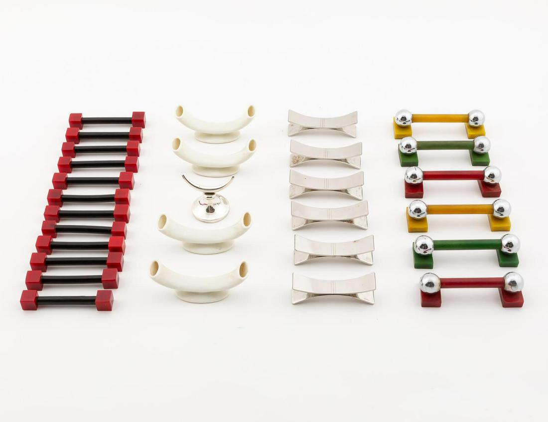 29 PCS ART DECO STYLE KNIFE RESTS: American, English, and Continental, 20th century. Group of twenty-nine Art Deco style knife rests comprising of one English sterling horn form rest, six Letang & Remy stainless steel rests, four ceram