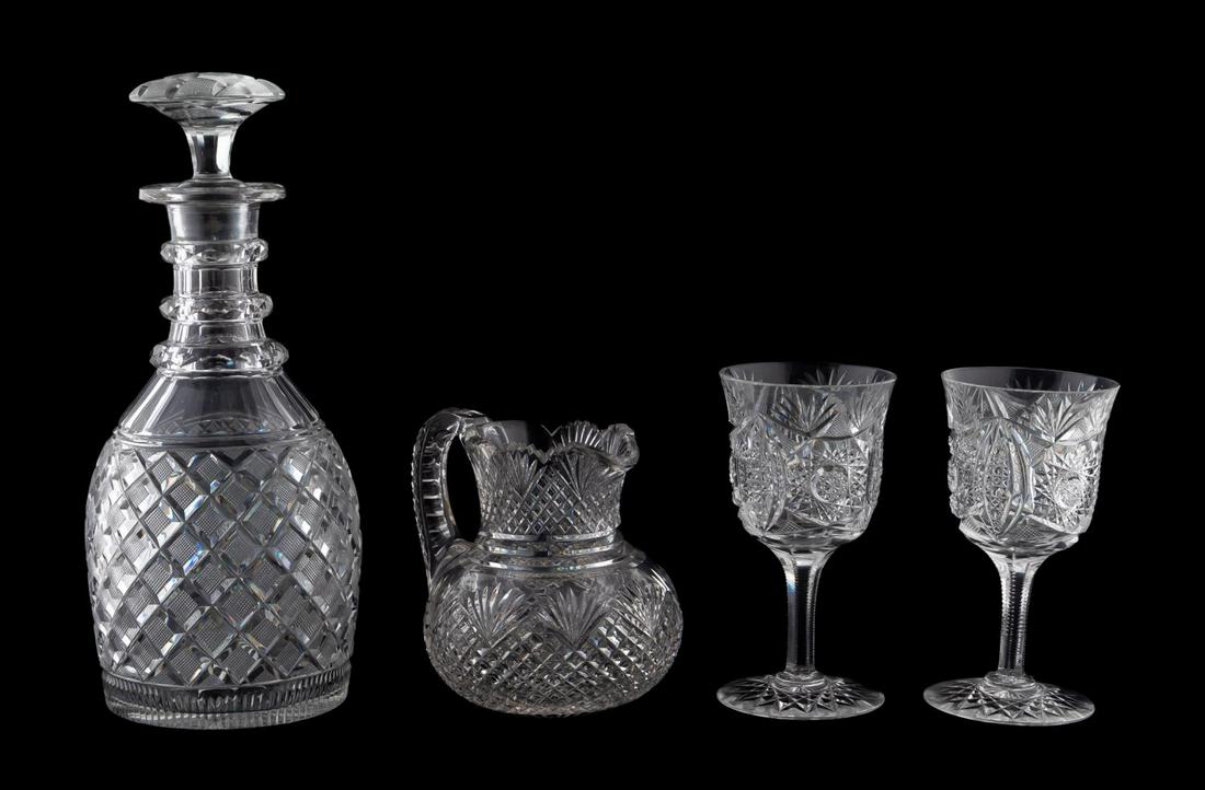 4 AMERICAN BRILLIANT CUT GLASS DRINKWARE PIECES: American, 19th / 20th century. Group of four brilliant cut glass tablewares comprising of one large decanter, two wine goblets and one pitcher. Apparently unmarked. Approx. h. 11" (decanter), h. 5" (p