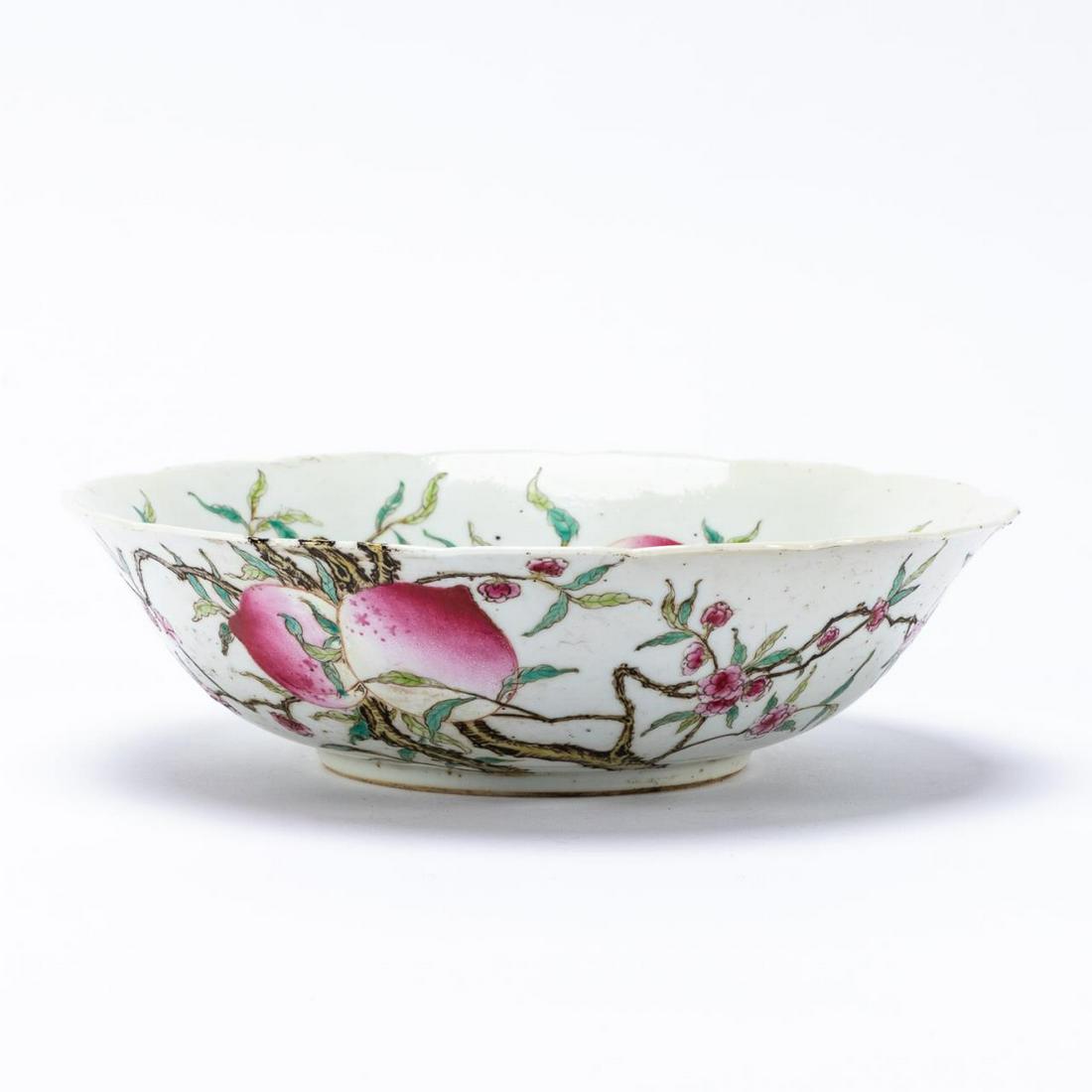 CHINESE PRUNUS MOTIF PORCELAIN BOWL: Chinese. Bat and prunus pattern porcelain serving bowl with ruffled rim. Character mark to underside. Approx. h. 2.625", diam. 9.375".