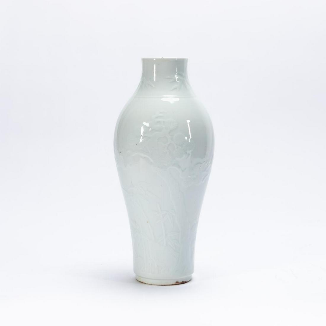 CHINESE CARVED BLANC DE CHINE LIUYEPING VASE: Chinese. Carved liuyeping or will leaf form vase blanc de chine or white glazed porcelain vase, the body decorated with a bat in a landscape. The base drilled. Approx. h. 11.25".