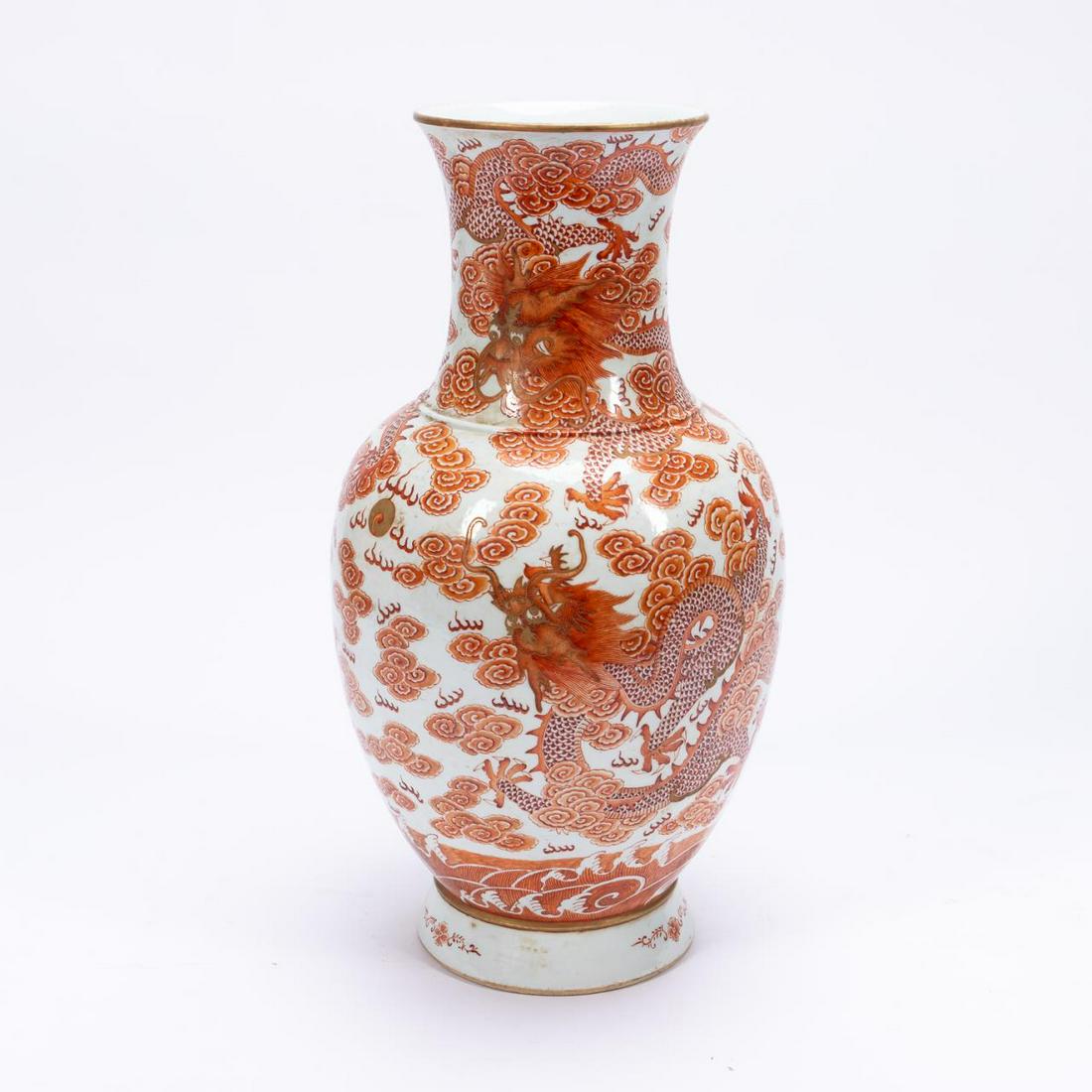 CHINESE IRON RED DRAGON & PEARL FENGWEIZUN VASE: Chinese. Parcel gilt iron red fengweizun or phoenix tail footed porcelain vase, decorated with dragons in a cloudy sky with bats chasing a pearl, and waves at the base. Having a Daoguang type mark to 