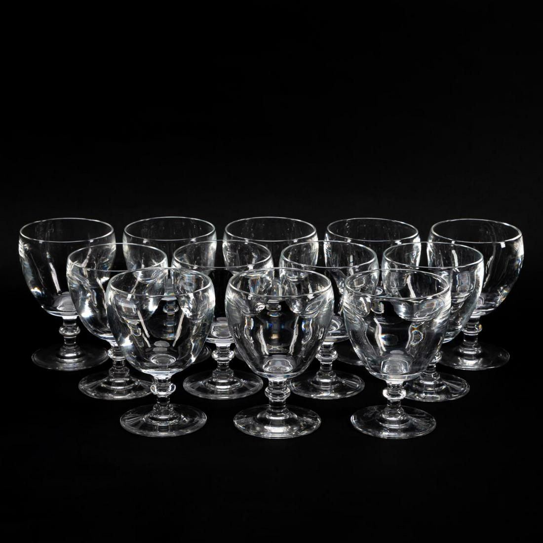 SET OF 12 STEUBEN CRYSTAL WINE GOBLETS, PAT. 6268: Steuben (American), second quarter 20th century. Twelve colorless wine glasses with knop stem and wafer foot. Pattern 6268. Accompanied by original box and nine dust bags. Appropriately marked to unde