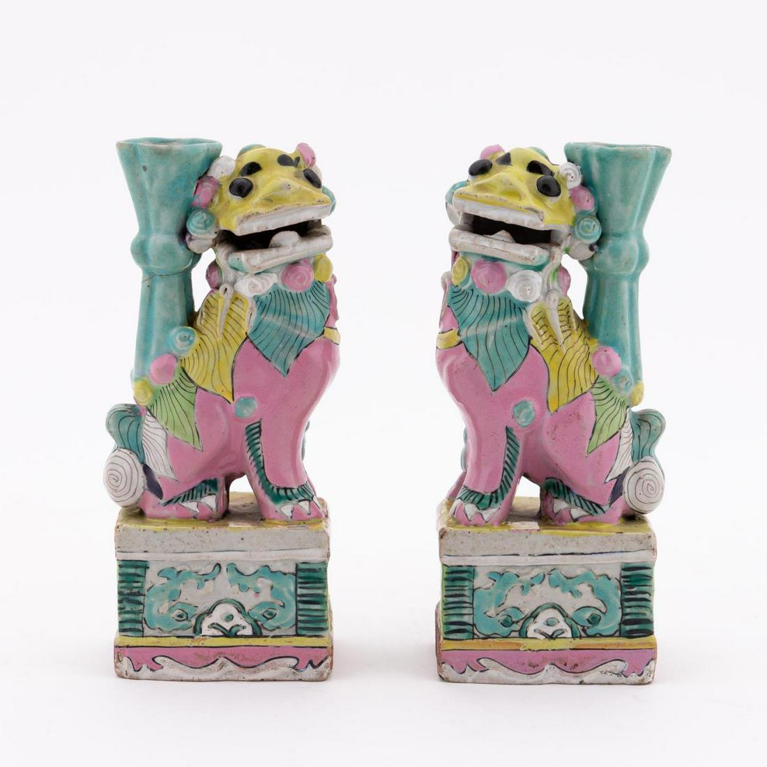 PR. FAMILLE ROSE BUDDHIST LION INCENSE HOLDERS: Chinese. Pair of mirror image seated guardian lion jostick holders on attached base. Apparently unmarked. Approx. h. 6.25".