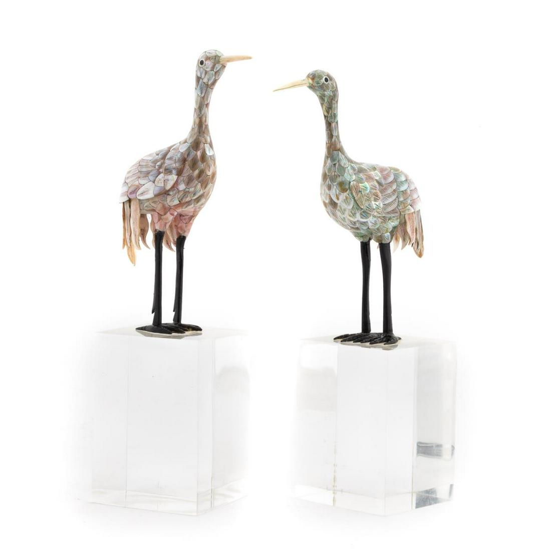 PAIR, MOTHER OF PEARL CRANES ON LUCITE BASES: Southeast Asian, 20th century. Pair of mother of pearl accented crane figures with black lacquered legs and carved bone beaks. Both attached to Lucite bases. Apparently unmarked. Approx. h. 11.5" (on 