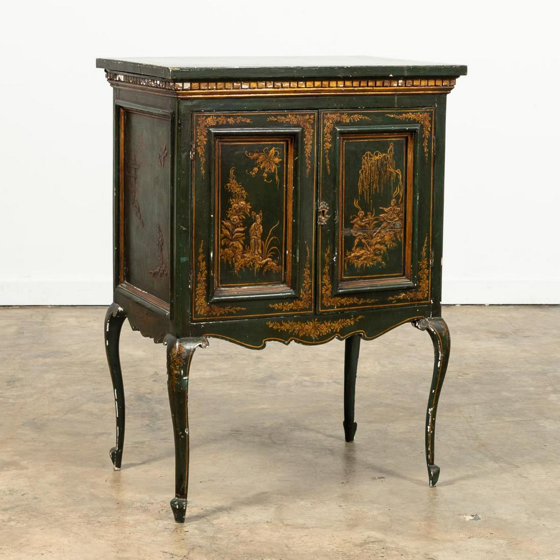 GREEN JAPANNED CHINOISERIE TWO-DOOR CABINET: Italian, 20th century. Green japanned two-door figural and floral chinoiserie decorated cabinet in the Queen Anne rococo taste, having a flip-top, and rising on cabriole legs. Paper country of origin 