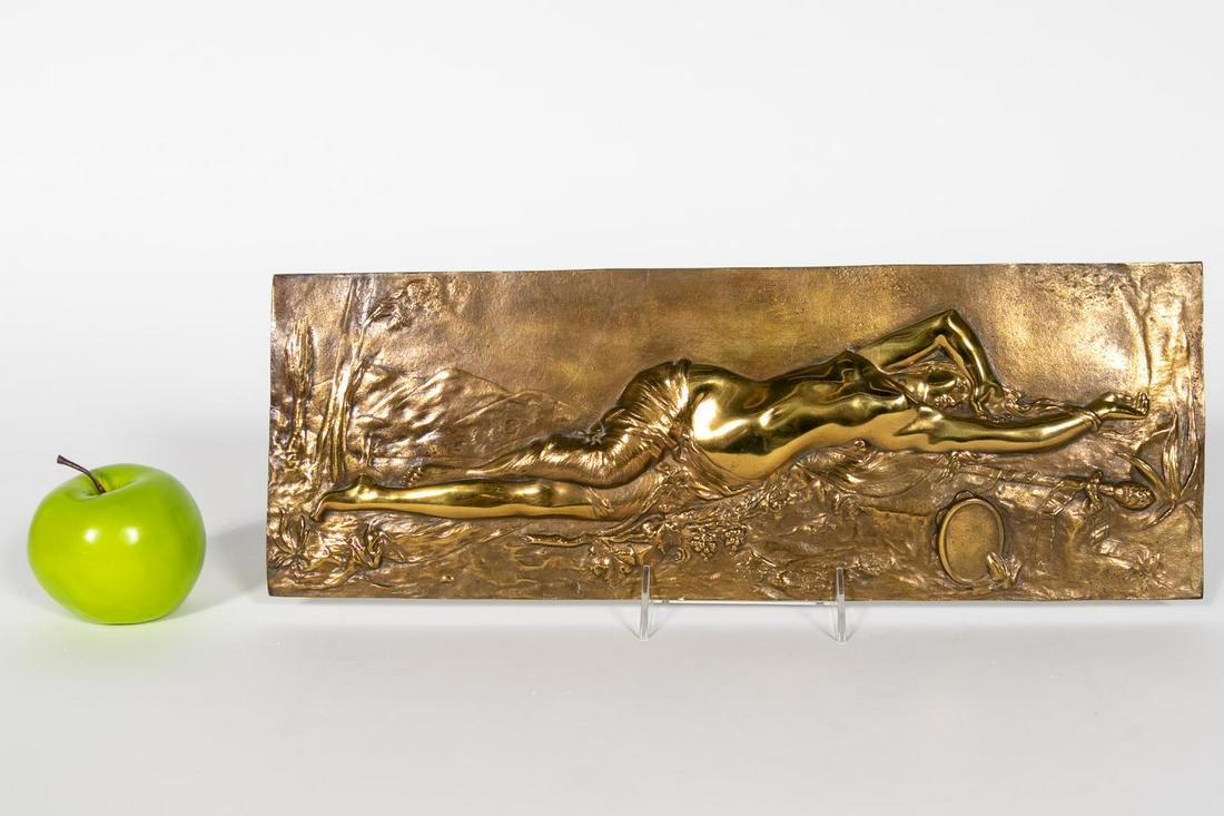 STYLE OF BERGMAN, ART NOUVEAU NUDE BRONZE PLAQUE: Continental, 20th century. Art Nouveau nude gilt bronze plaque depicting a reclining nude women with tambourine set in front of a landscape with mountains and trees. Marked "P.S." verso. Approx. h. 6.