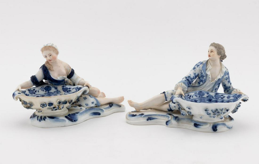 PAIR, MEISSEN "BLUE ONION" FIGURAL SWEET MEATS: Meissen (German, founded 1720), 1815-1924. "Cavalier on Bowl" and "Dame on Bowl" (Kavalier an Schale - model 2872 and Dame an Schale - model 2875), originally modeled by Johann Joachim Kandler, "Blue 