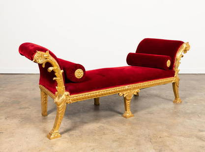 GEORGE II-STYLE VELVET UPHOLSTERED GILTWOOD BENCH: Manner of John (1718-1765) / Thomas Vardy (1751–1788), and William Kent (1685-1748), carved giltwood bench or daybed in the George II taste, having a canted-form, red velvet upholstery with two bols