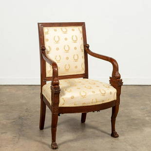 EMPIRE WALNUT FAUTEUIL, ATTR. JACOB-DESMALTER: Attributed Francois-Honore-Georges Jacob-Desmalter (French, 1770-1840), first 19th century. Carved walnut empire fauteuil armchair, having dolphin-form arm supports and rising on animal-form front leg