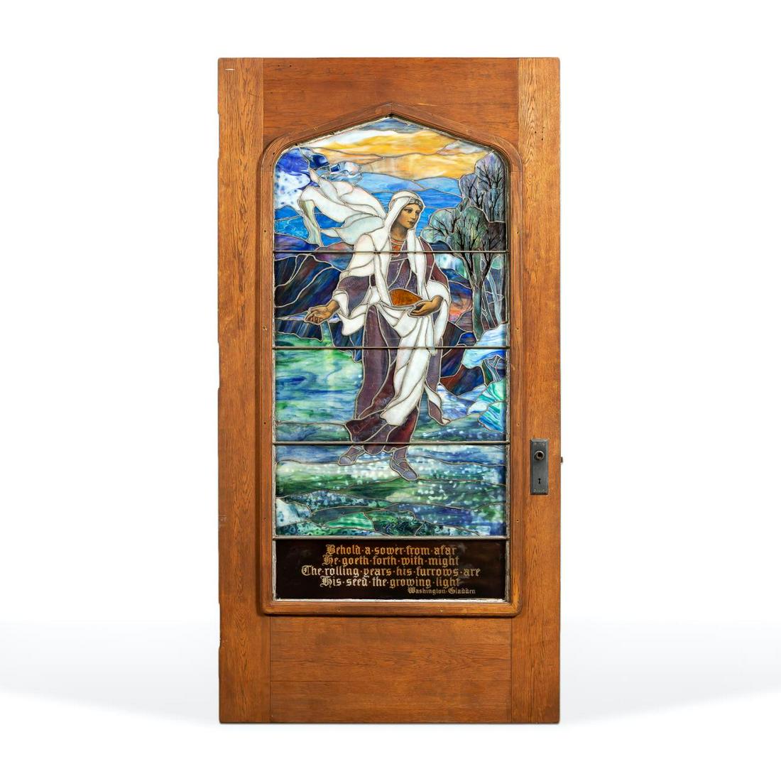 TIFFANY STUDIOS "THE SOWER" FAVRILE GLASS DOOR: Tiffany Studios (American). "The Sower" - circa 1920s, leaded and plated Favrile glass panel in oak door. Female figure is the seed sower. Accompanied by Melvil Dewey: Seer-Inspirer-Doer 1851-1931 by