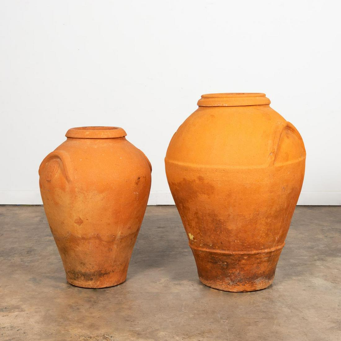 TWO JAMAICAN TERRA-COTTA WATER-COOLING JARS: Jamaican, 19th century or older. Group of two terra-cotta water cooling jars, having rolled rims and integral handles. Both with impressed marks. Note: A similar jug can be seen in Isaac Mendes Belisa