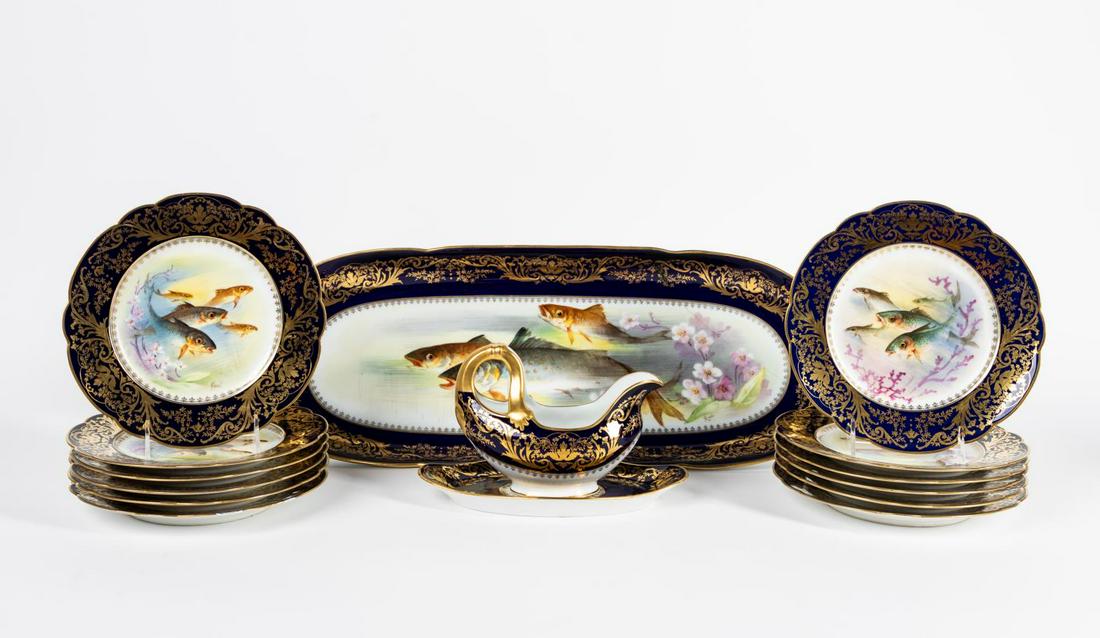 LIMOGES PORCELAIN COBALT & GILT FISH SERVICE, 15PC: R. DeliniÃ¨res & Cie. and L. Bernardaud & Cie. (French), 1895-1900. Fifteen piece Limoges porcelain fish service, having a cobalt-ground lip with scrolled parcel gilt decoration, each piece having a