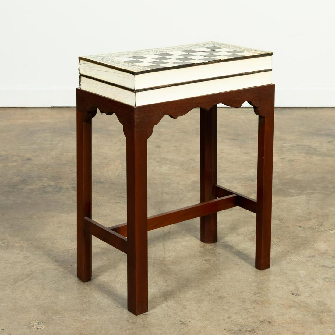 BOOK-FORM BONE BACKGAMMON/CHECKERS SET ON STAND: Bone inlaid book-form wooden board/case, with sixteen bone black and sixteen white game pieces, two bone cups, and three dice, on wooden stand. Unmarked.