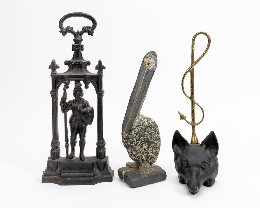 TWO IRON DOORSTOPS & MIXED STONE PELICAN FIGURE (1 of 7)