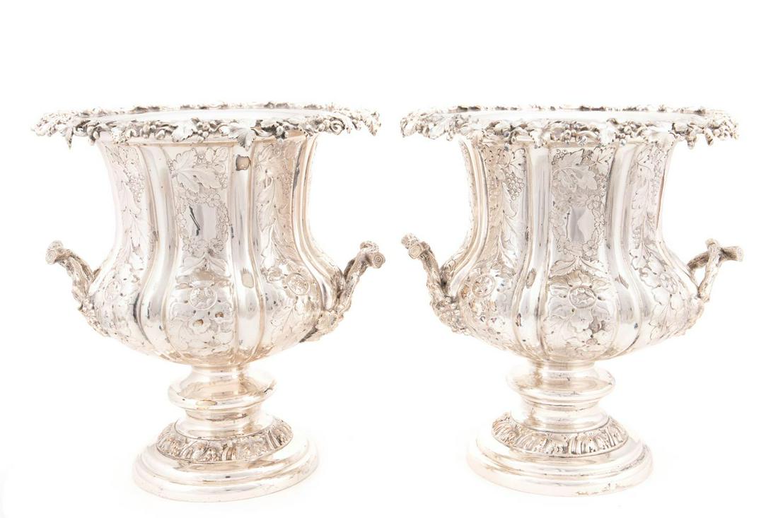 PAIR, SILVERPLATE GRAPE VINE MOTIF WINE COOLERS: English,19th/20th century, pair, of silverplate campagna form grape motif wine coolers, each having a repousse body, vine handles, and spreading dome foot, apparently unmarked. Provenance: From the Pr