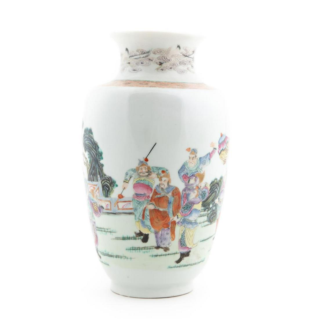 CHINESE FAMILLE ROSE BALUSTER VASE: Chinese Famille Rose baluster vase, having a flared rim above a neck with flying cranes and auspicious cloud forms, the tapering body decorated with a scene of a courtier and an old warrior meeting th