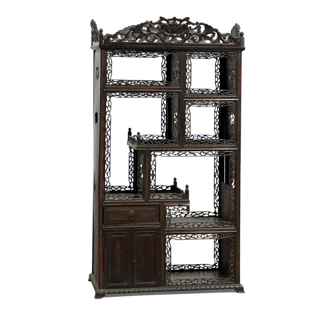 DIMINUTIVE CHINESE ZITAN ASYMMETRICAL CURIO: Diminutive double sided Chinese zitan asymmetrical curio, of rectangular form, having a carved peony crest above seven asymmetrical shelves, one drawer and two small doors, the shelves faced with pier