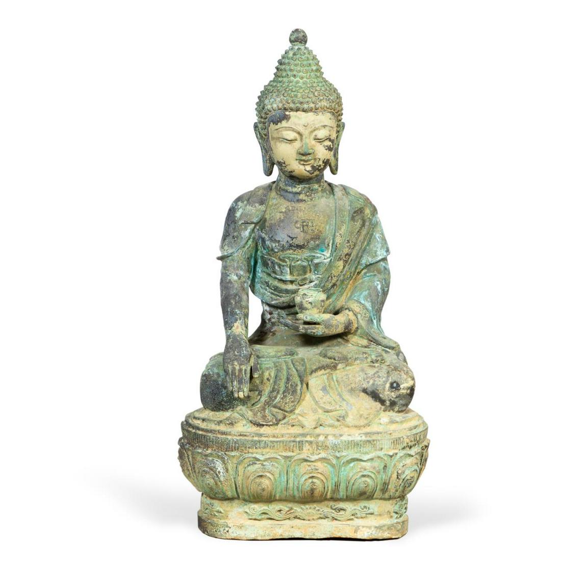 MONUMENTAL PATINATED METAL SHAKYAMUNI BUDDHA: Monumental patinated metal seated Shakyamuni Buddha, depicted holding a vessel in one hand and performing the Bhumisparsha or earth touching mudra with the other, resting on a lotus base with verdigri