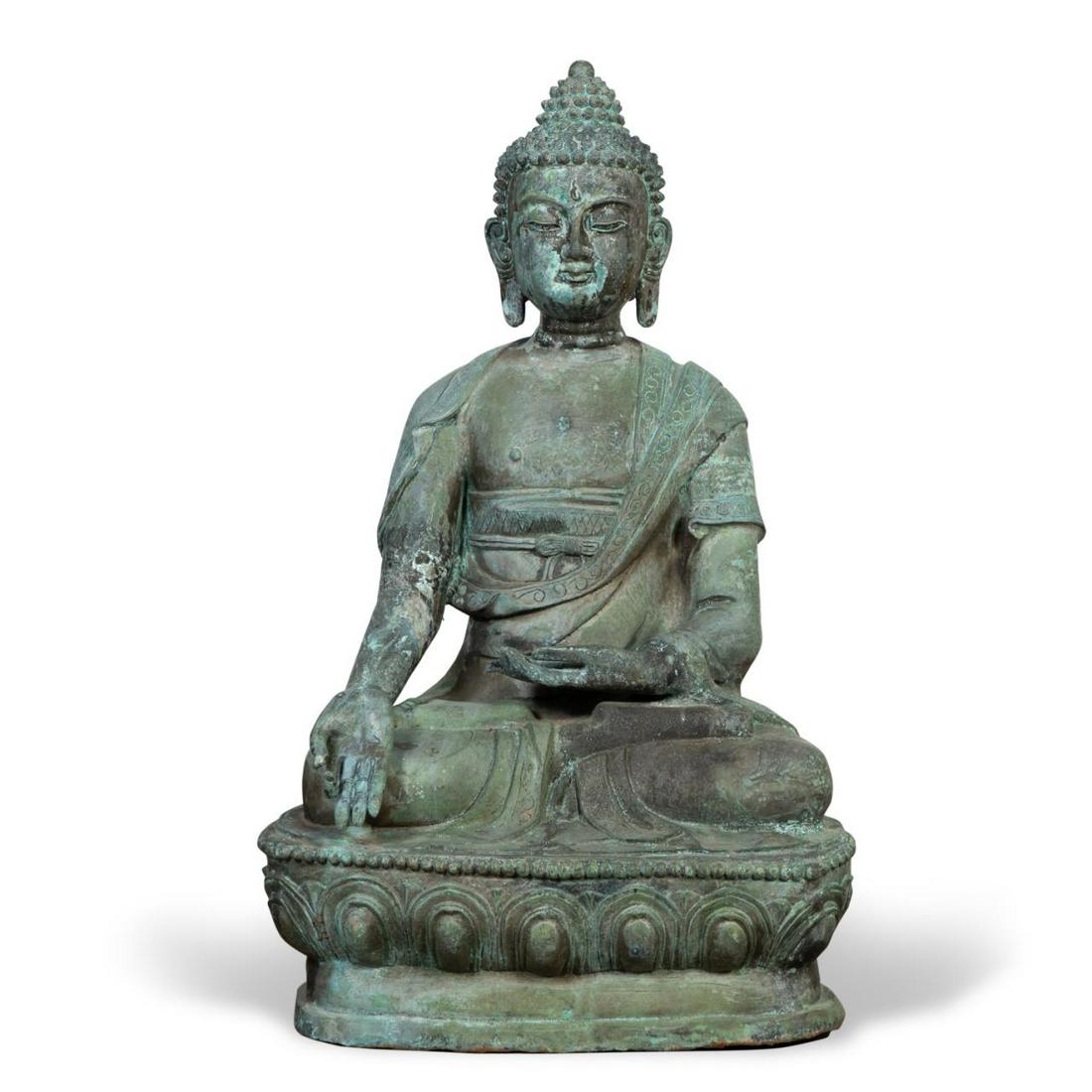 MONUMENTAL PATINATED METAL SEATED MEDICINE BUDDHA: Monumental patinated metal and parcel gilt seated Medicine Buddha, depicted wearing a robe with incised gilt floral decoration, holding a vessel with a plant in one hand and having the other across th
