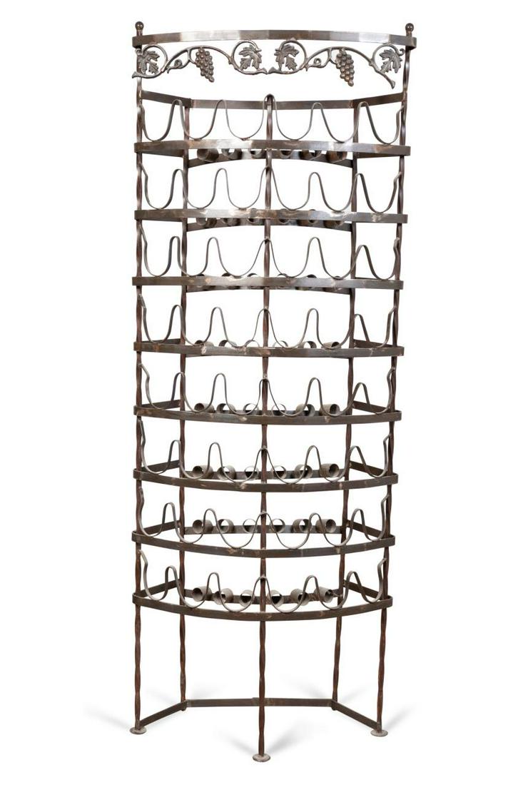 CURVED FORTY-EIGHT BOTTLE WROUGHT IRON WINE RACK: Curved wrought iron wine rack, having a scrolled grape vine band and cradles for forty-eight bottles, apparently unmarked. Approx. h. 81", w. 30.5", d. 14.5".