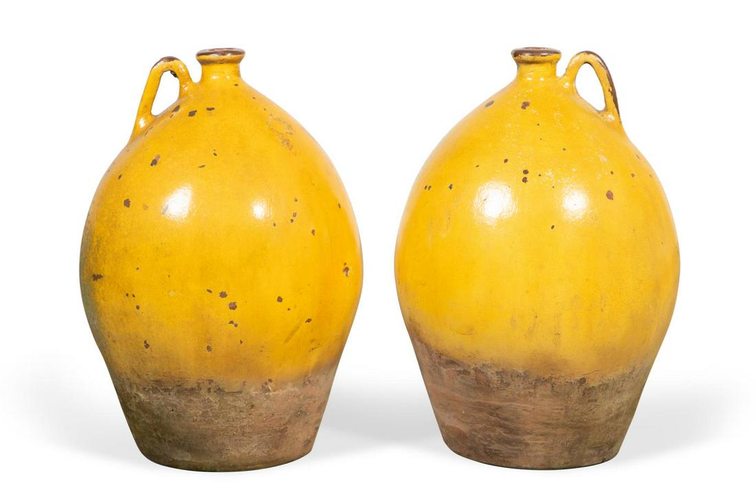 PR., LARGE YELLOW GLAZED BULBOUS POTTERY WINE JARS: Continental, likely Italian or Spanish, pair of bulbous pottery wine or oil jars, each having a single handle, apparently unmarked. Provenance: From the Private Collection of Veronica Holmes, Atlanta,