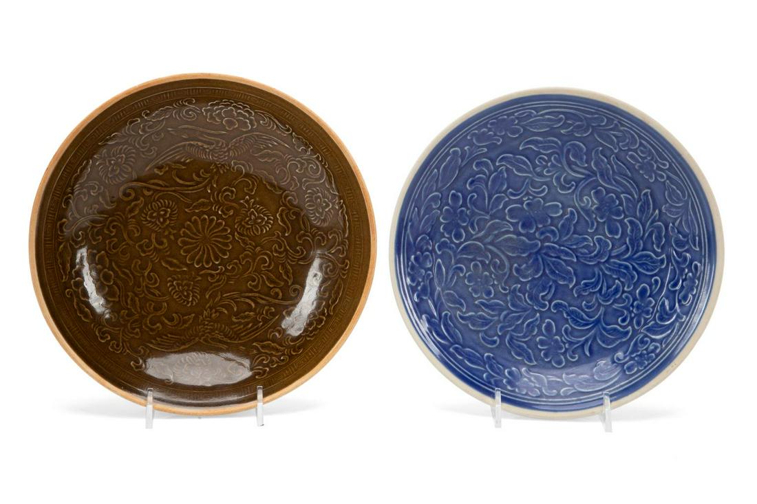 TWO CHINESE YUAN STYLE LOW BOWLS: Two Chinese Yuan style low bowls, the first, finely potted, the interior having a molded phoenix and peony design with chocolate glaze and a bare rim, h. 1.75", dia. 8.25"; the second with a molded fo