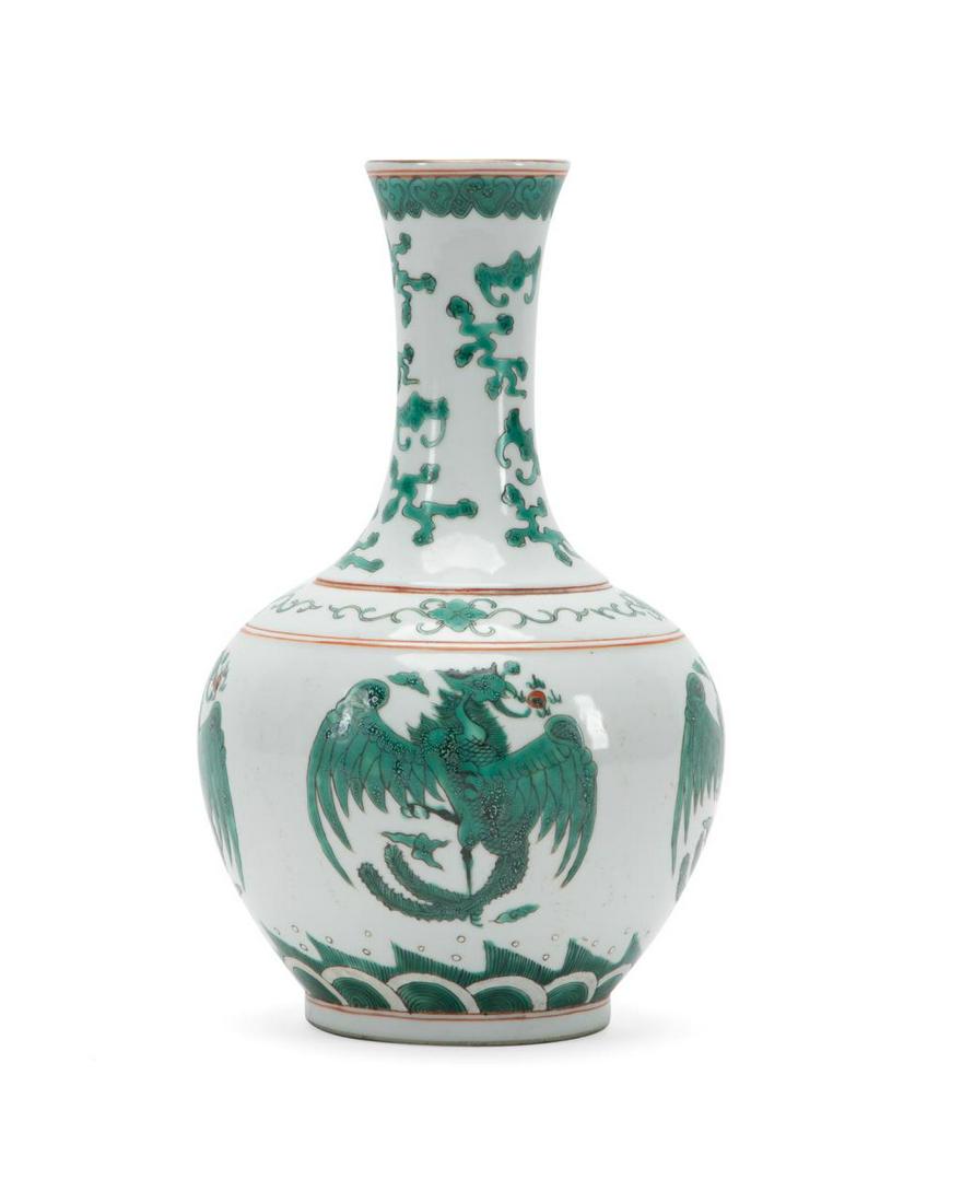 CHINESE GREEN AND WHITE PHOENIX & BAT VASE: Chinese green and white phoenix and bat vase, of bottle form, having a trumpet neck with scattered bats above a body decorated with phoenixes, the underside having a red, six character Daoguang style 