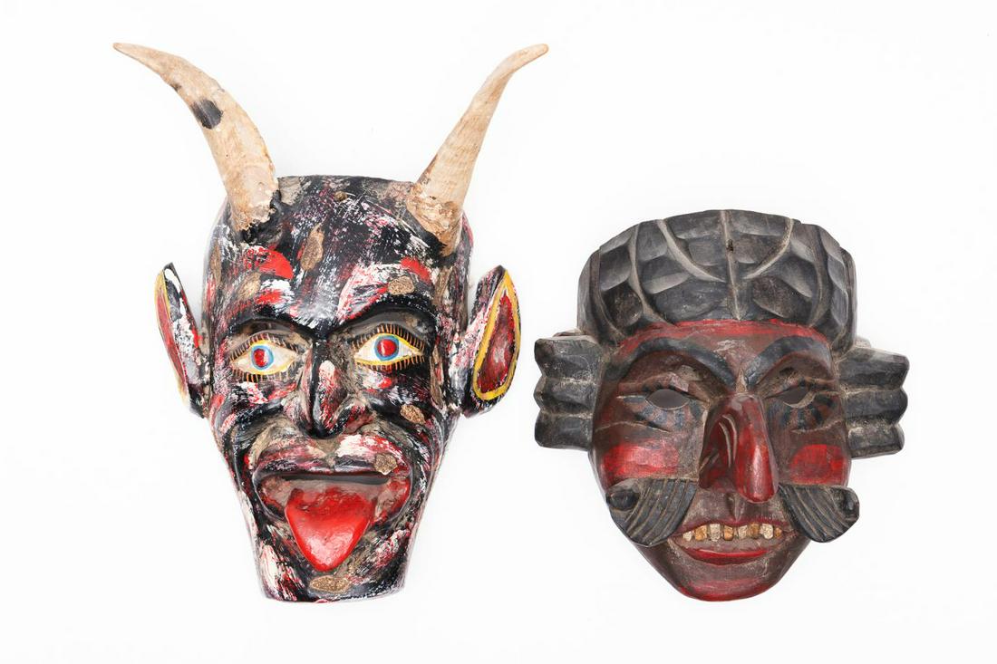 TWO CARVED WOOD MASKS, MEXICO & INDONESIA: Two carved wooden masks, Mexico & Indonesia, executed in painted wood, the Mexican mask depicting a devil with ram's horns above a multi color face flanked by large ears and tongue, h. 12.5", w. 8", d