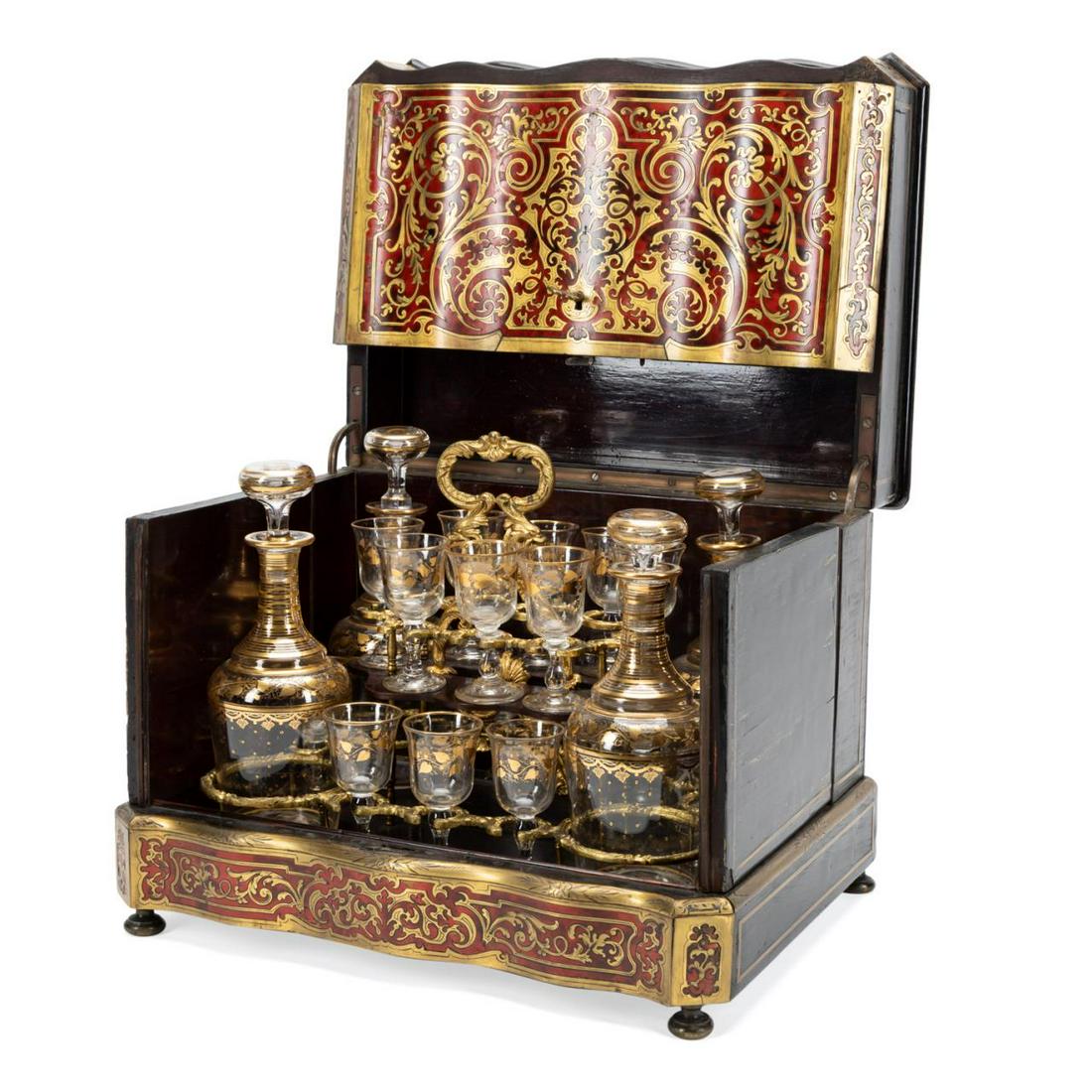 NAPOLEON III BOULLE INLAID FITTED CAVE A LIQUEUR: French twenty-one piece Napoleon III boulle brass inlaid, ebonized, and rosewood veneer cave a liqueur, 19th century, having a removable tray fitted with gilded bronze holders and four gilded colorles