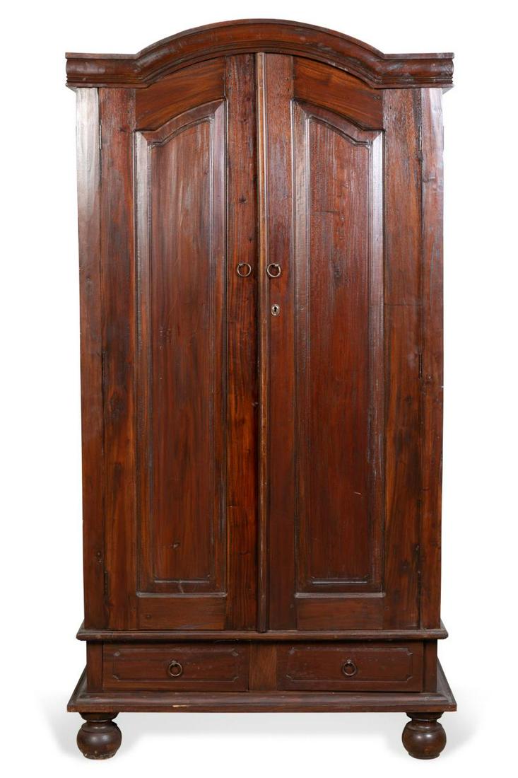 ANGLO-DUTCH CARIBBEAN STYLE ARMOIRE: Hardwood armoire in the Anglo-Dutch Caribbean taste, having double-arched paneled doors above two drawers, the interior fitted with shelves, and rising on bun feet, apparently unmarked. Approx. h. 80.