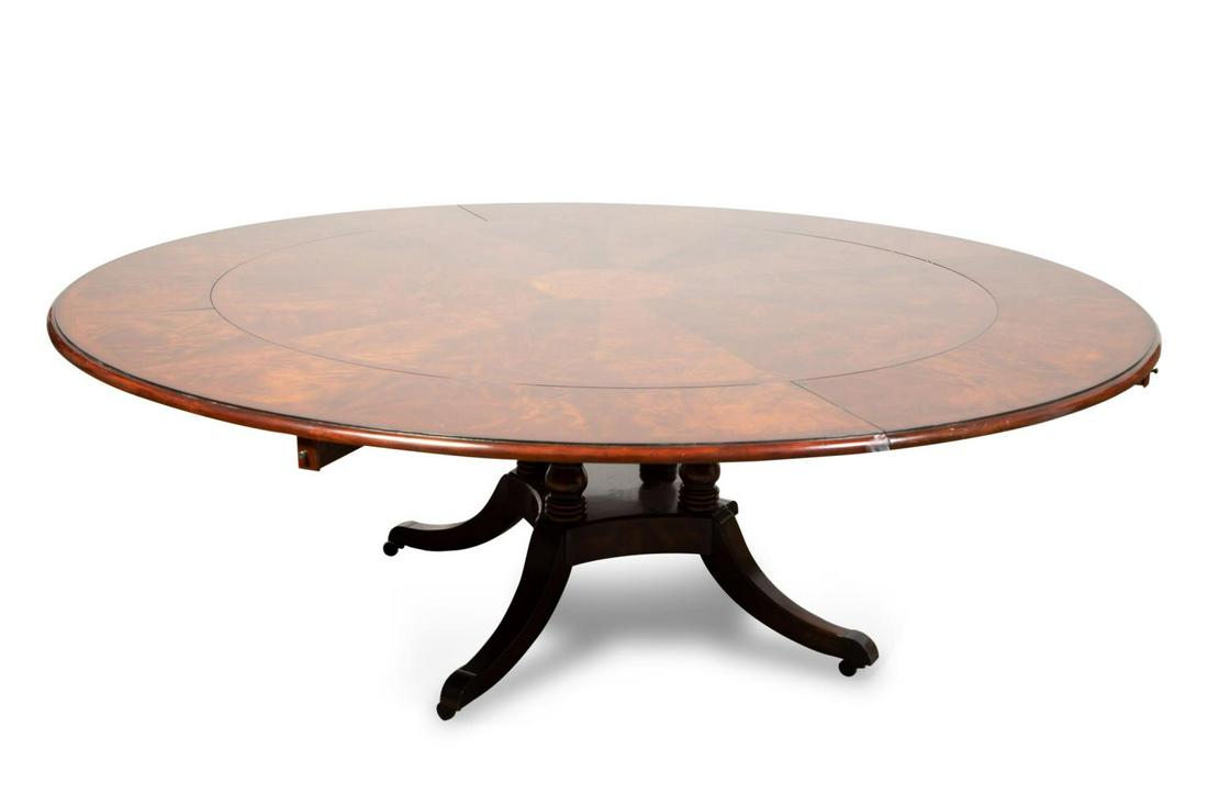THEODORE ALEXANDER "BROOK STREET" DINING TABLE: Theodore Alexander "Brook Street" mahogany supper dining table in the Regency taste, having circular top with flame and burl inlay, four banded crescent leaves, and rising on a turned four part pedest