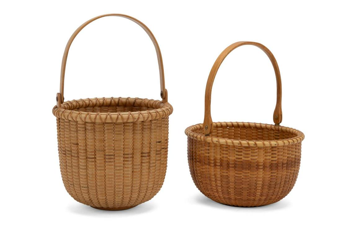2 ROUND OPEN NANTUCKET BASKETS, FOREMAN & HALA: Two American School Nantucket woven baskets in wood and rattan having a round form and swivel handle, the largest having a carved whale to center interior, smaller basket signed Ani Foreman and dated 
