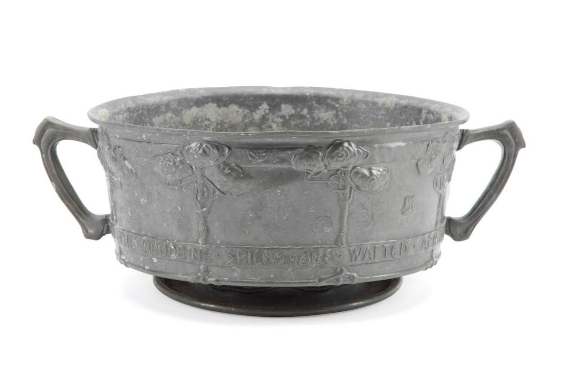 LIBERTY & CO. "TUDRIC" PEWTER BOWL, C. 1900: David Veasey for Liberty and Company (English 1875) Arts and Crafts "Tudric" pewter double handled bowl, circa 1900, having stylized rose bushes in relief above the text, "And the woodbine spices are 