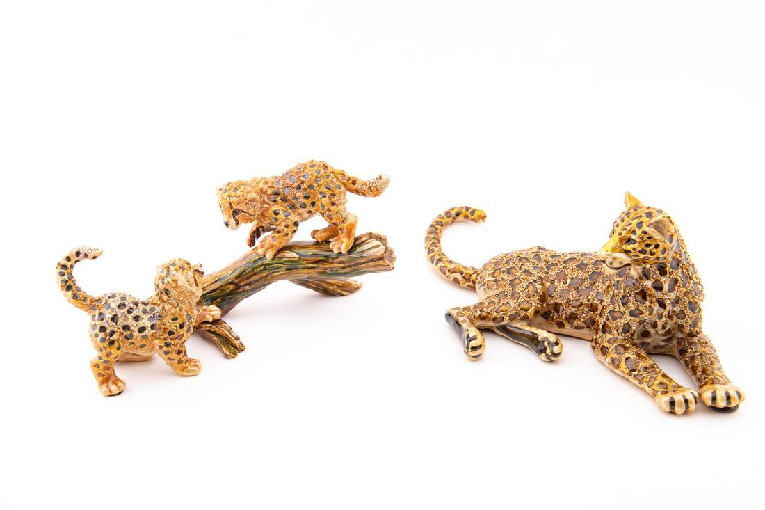 TWO JAY STRONGWATER JUNGLE CAT FIGURINES: Two Jay Strongwater (American 1995) jungle cat figurines, comprising one recumbent leopard and one figure of leopard cubs playing on a log, both in pewter, enamel, and accented with crystals, both hav