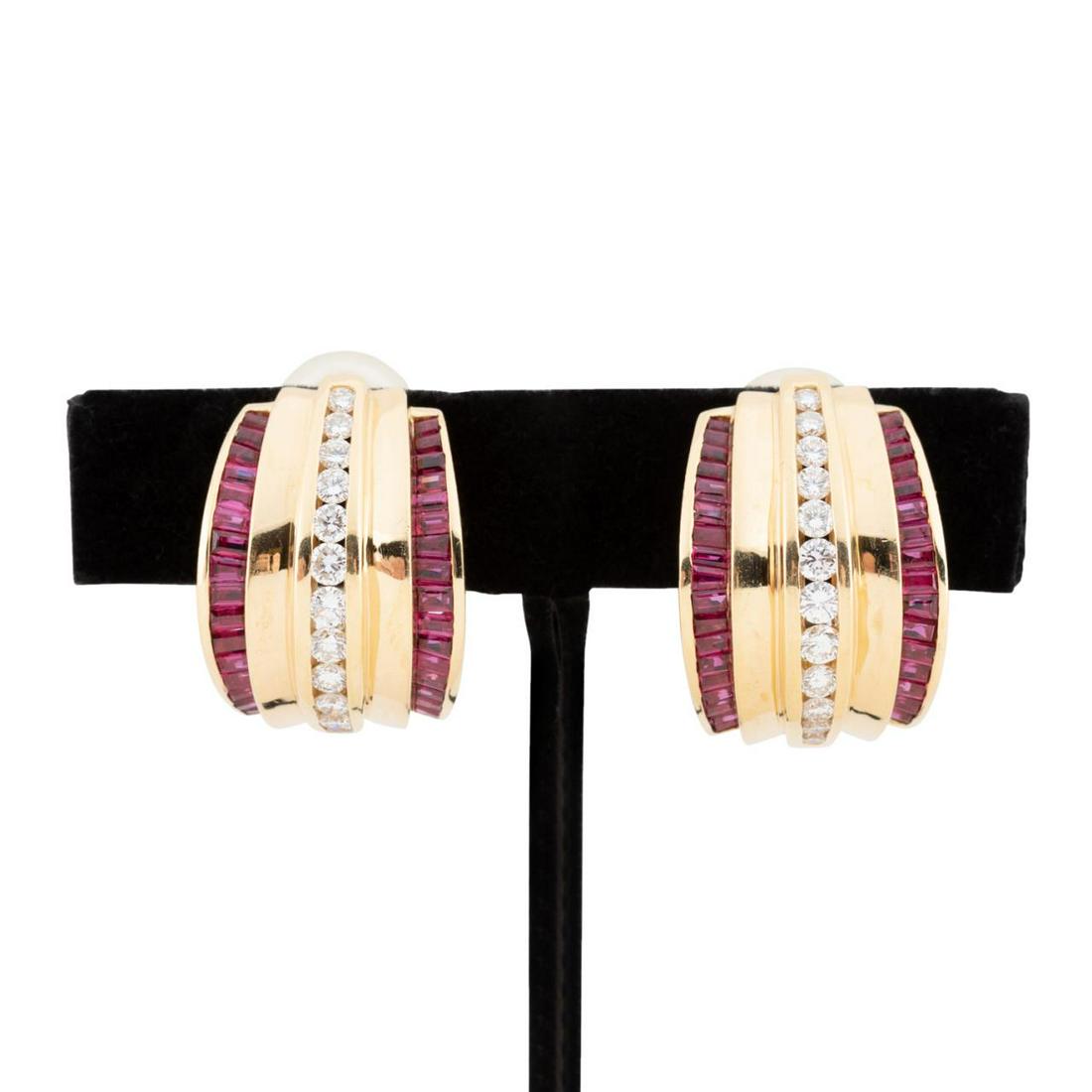 PR. CHARLES KRYPELL 18K, DIAMOND & RUBY EARRINGS: Pair of Charles Krypell 18k yellow gold, ruby and diamond huggie clip earrings, having (64) baguette shape rubies, weighing approximately 7.0 ctw, flanking (24) round brilliant cut diamonds weighing a