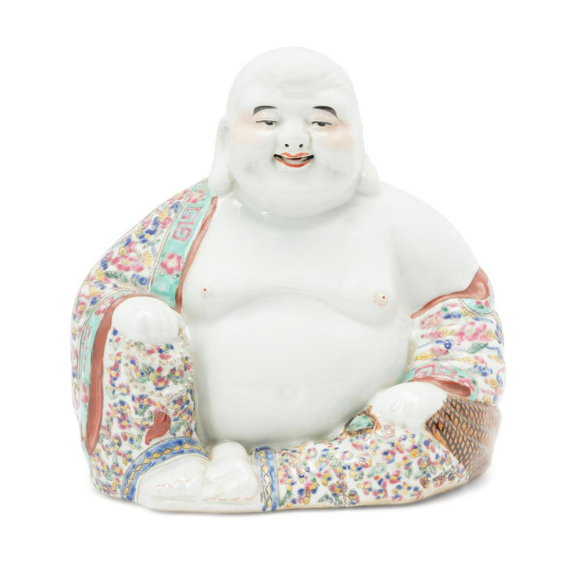 CHINESE ROSE FAMILLE LAUGHING BUDDHA: Chinese Rose Famille laughing Buddha, seated in the traditional pose, holding prayer beads in one hand and wearing a floral robe embellished with scattered roundels holding Shou characters, having an 
