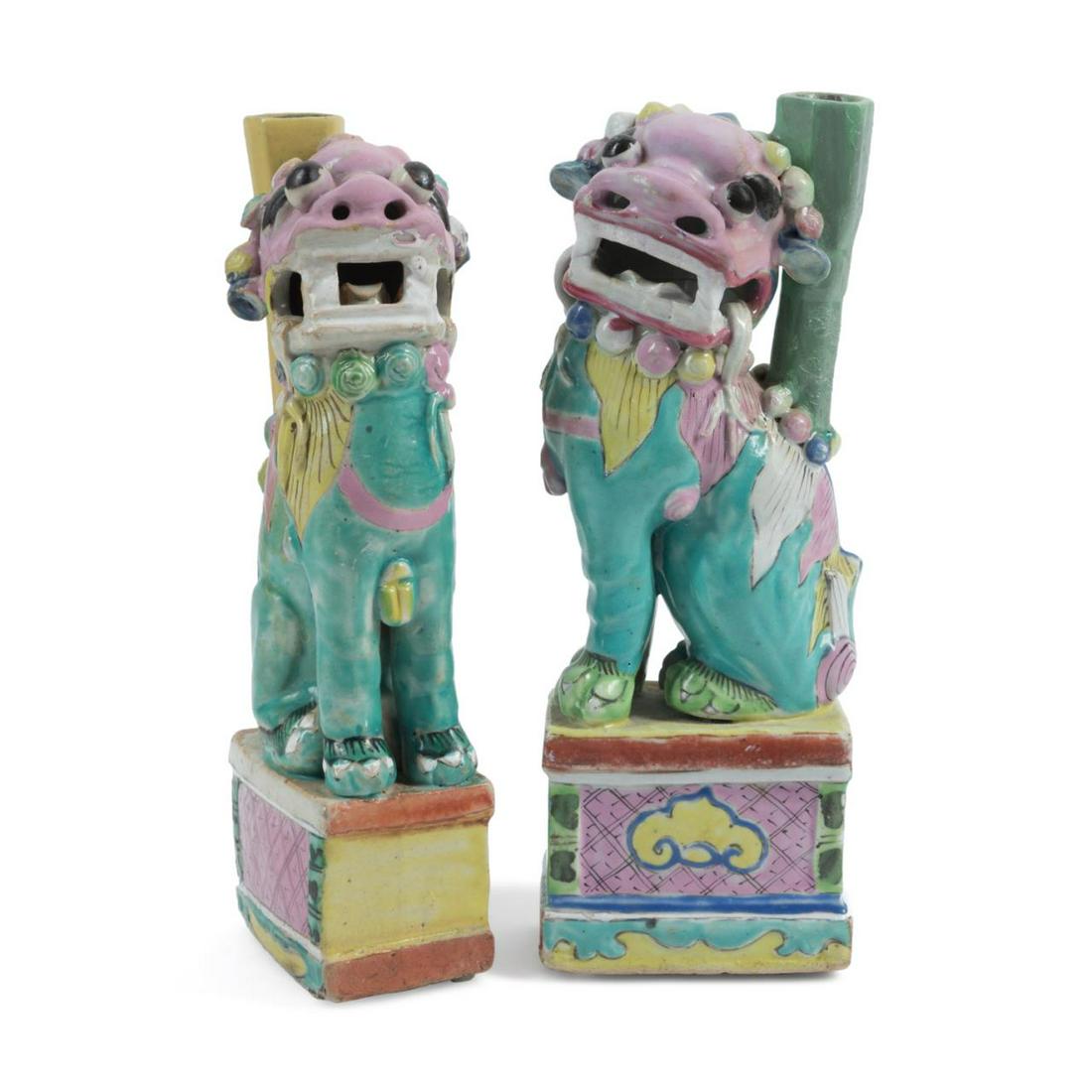 PAIR CHINESE POLYCHROME FU LION VASES: Pair of Chinese polychrome Fu Lion spill vases or incense holders, modeled as seated guardian lions glazed in turquoise, pink, yellow, and white with a yellow or celadon vase issuing from the back, th